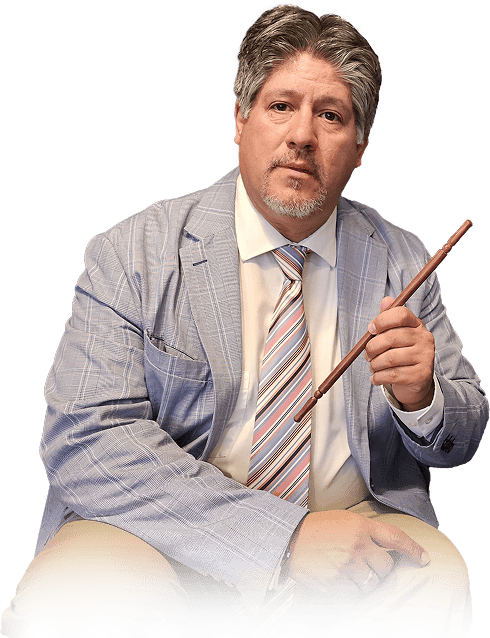 Frank Greer a professional magician, mentalist and entertainer based in San Antonio sitting in a chair and holding a magic wand.