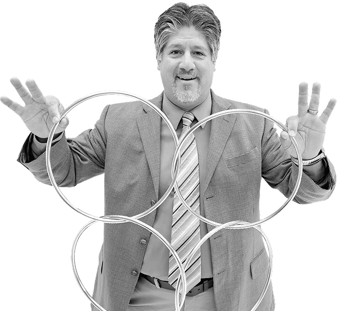 Frank Greer in a suit performing a linking rings magic trick, demonstrating illusion skills with metal rings in San Antonio