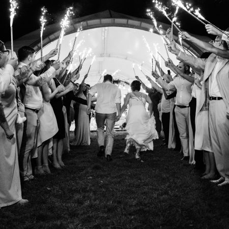cold fire from cake candles and fireworks in the hands of people around the newlyweds